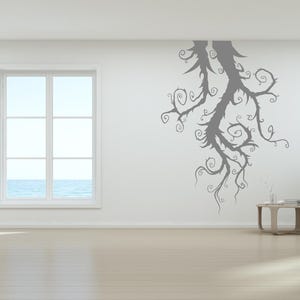 Nature wall art shaped by dramatic curves and reaching branches, echoing forest imagery with an artistic edge.