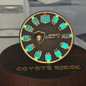 May include: A set of three ceramic mugs with a speckled, matte finish. The mugs are in shades of cream, light gray, and dark gray. Each mug has a simple, minimalist design, perfect for coffee or tea.