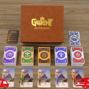 Puede incluir: Un juego de cartas Gwent en caja marr&oacute;n, con el texto "Gwent The Witcher Card Game" en letras doradas. El juego incluye varias barajas de cartas con varios s&iacute;mbolos e ilustraciones, y una peque&ntilde;a tarjeta de instrucciones. Las cartas est&aacute;n dispuestas sobre una superficie de madera.