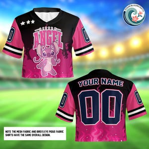 a pink and black football jersey with a pink and black design, including a cartoon character and text. The jersey has a black collar and sleeves, and the back has the text "YOUR NAME 00" along with a number "00". The jersey is displayed against a blurred background, which appears to be a grassy field.