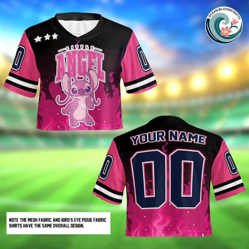 a pink and black football jersey with a pink and black design, including a cartoon character and text. The jersey has a black collar and sleeves, and the back has the text "YOUR NAME 00" along with a number "00". The jersey is displayed against a blurred background, which appears to be a grassy field.