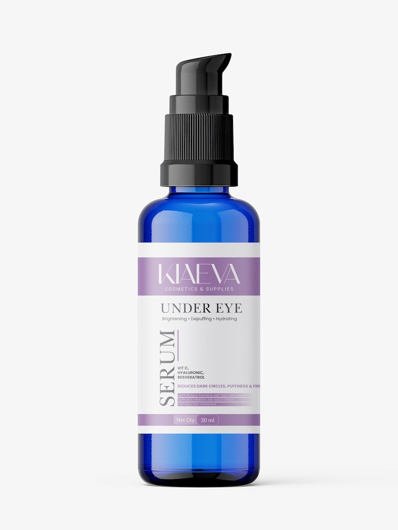May include: A blue glass serum bottle with a black pump dispenser. The label reads "KIAEVA COSMETICS & SUPPLIES UNDER EYE SERUM" with text indicating it reduces dark circles and puffiness. The bottle contains 30 ml of product.