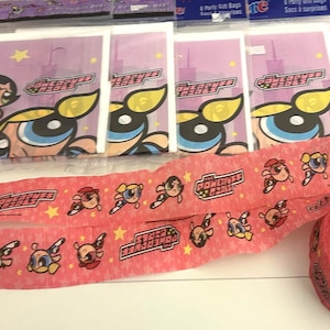 May include: A set of Powerpuff Girls party gift bags in clear plastic packaging and a roll of pink crepe paper streamer featuring a repeating pattern of the Powerpuff Girls characters and the Powerpuff Girls logo with small yellow stars.