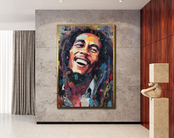 May include: A vibrant, framed portrait of a smiling man with dreadlocks. The artwork features a colorful, expressive style with a gold frame. The subject's face is the focal point, showcasing a joyful expression.