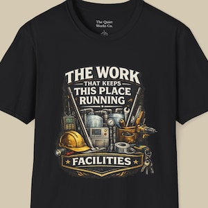 May include: Black t-shirt with a graphic featuring the text "THE WORK THAT KEEPS THIS PLACE RUNNING" and the word "FACILITIES". The design includes tools, a hard hat, and other equipment, suggesting a facilities or maintenance theme.