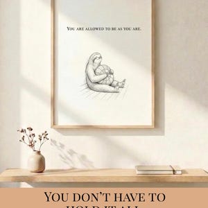 May include: A framed print with a light wood frame. The print features a line drawing of a sloth holding a globe, with the text "YOU ARE ALLOWED TO BE AS YOU ARE." Below, the text reads "YOU DON'T HAVE TO HOLD IT ALL. gentle reminder."