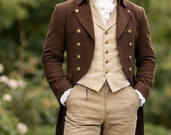 May include: A man in a brown frock coat, tan vest, and beige trousers, with black knee-high boots. The coat has gold buttons and a double-breasted design. A white ruffled cravat is visible at the neck. The outfit is reminiscent of historical attire.