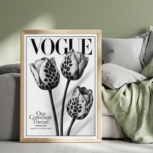 May include: A framed black and white Vogue magazine cover. The image shows three tulips with speckled petals. The magazine title is at the top, and the text "Our Common Thread" is at the bottom, with additional text below.