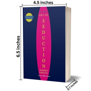 May include: A hardcover book titled "The Art of Seduction" by Robert Greene. The book has a dark blue cover with a vertical pink stripe and the title in white. The book is 6.5 inches tall, 4.5 inches wide, and 0.7 inches thick.