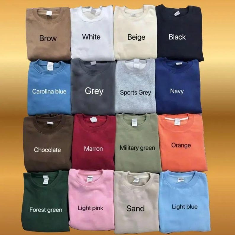 May include: A grid of sixteen crewneck sweatshirts in various colors, including brown, white, beige, black, Carolina blue, grey, sports grey, navy, chocolate, maroon, military green, orange, forest green, light pink, sand, and light blue. Each sweatshirt has a label with its color name.