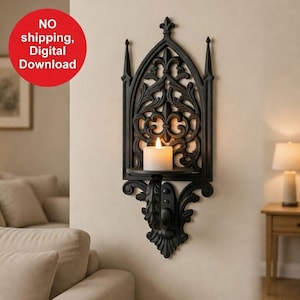May include: Black metal wall sconce with a gothic arch design. The sconce features ornate scrollwork and a small shelf holding a lit white candle. The design includes a fleur-de-lis at the top. The sconce is mounted on a beige wall.