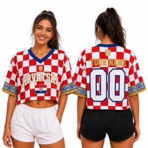May include: A cropped jersey featuring a red and white checkered pattern, a blue V-neck, and gold-trimmed sleeves with floral accents. The front displays the text HRVATSKA and a flag, while the back shows the text YOUR NAME and the number 00.