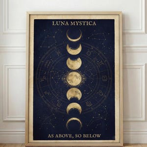 May include: Framed art print featuring a dark blue background with gold-colored illustrations of the moon phases and celestial symbols. The text "LUNA MYSTICA" and "AS ABOVE, SO BELOW" are displayed in gold lettering.