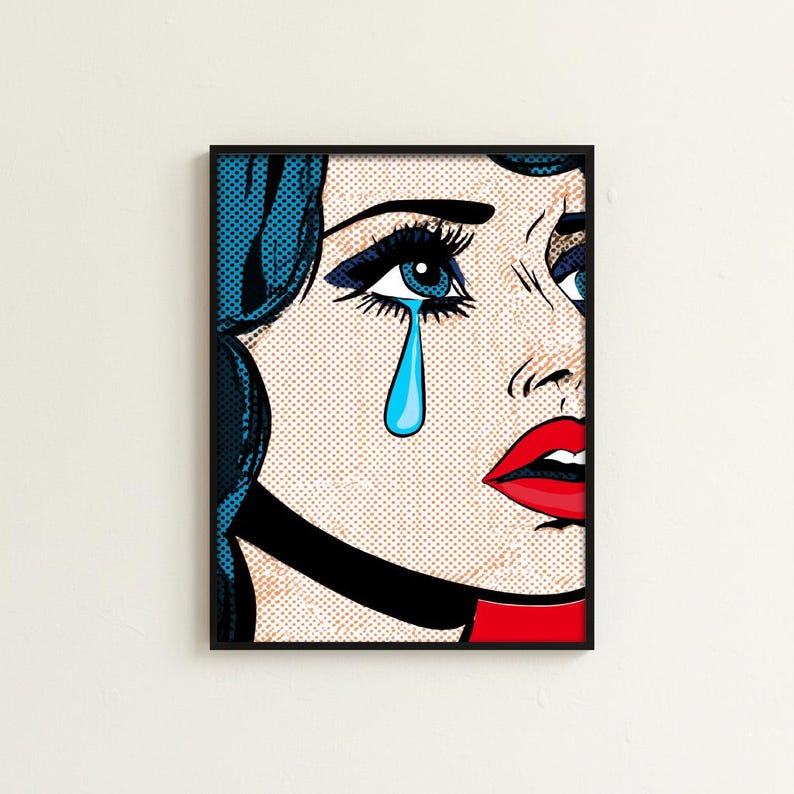 May include: Pop art print of a woman with blue hair and a tear falling from her eye. The artwork features bold lines, a black choker, and a red and black color scheme. The print is framed in a black frame.