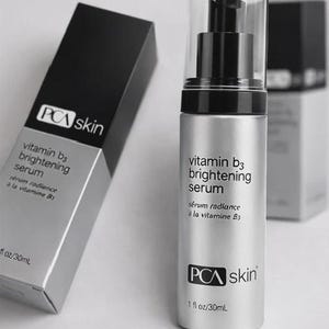 May include: A silver PCA skin Vitamin B3 brightening serum bottle with a black pump and clear cap. The product is in a black and silver box. The text on the bottle reads "vitamin b3 brightening serum".