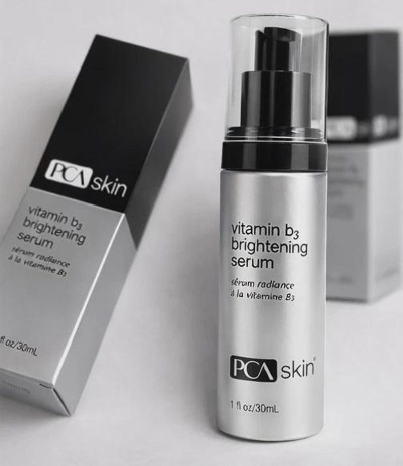 May include: A silver PCA skin Vitamin B3 brightening serum bottle with a black pump and clear cap. The product is in a black and silver box. The text on the bottle reads "vitamin b3 brightening serum".