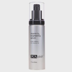 May include: A silver-colored bottle of PCA Skin Vitamin B3 Brightening Serum. The bottle has a black pump and a clear plastic cap. The label includes the text "vitamin b3 brightening serum" and "serum radiance &agrave; la vitamine B3". The bottle contains 1 fl oz / 30mL.