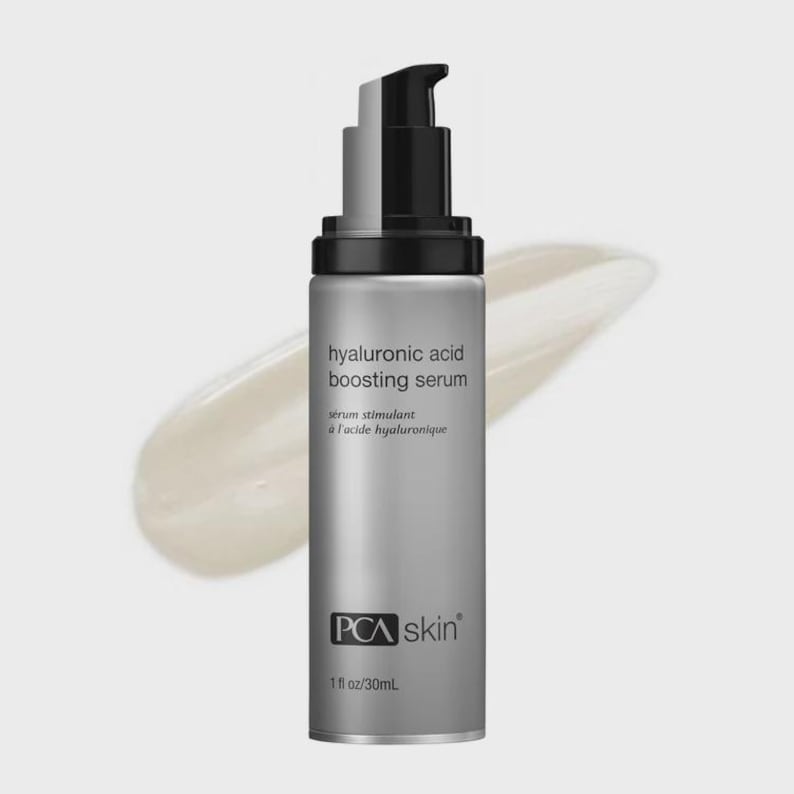 May include: A silver PCA skin hyaluronic acid boosting serum bottle with a black pump dispenser. The bottle has white text that reads "hyaluronic acid boosting serum" and "serum stimulant &agrave; l'acide hyaluronique". The bottle contains 1 fl oz/30mL of product.