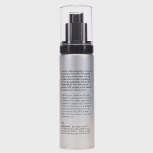 May include: A silver and black PCA SKIN treatment bottle with a clear plastic cap. The bottle has a pump dispenser and contains text in English and French. The text describes the product's use for skin brightening and anti-aging benefits.