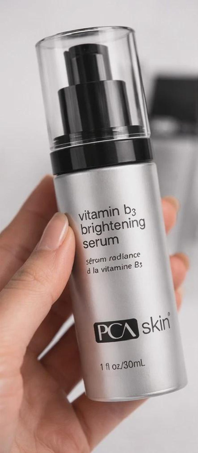 May include: A silver bottle of PCA Skin Vitamin B3 Brightening Serum. The bottle has a black pump and a clear cap. The label includes the text "vitamin b3 brightening serum" and "1 fl oz/30mL".
