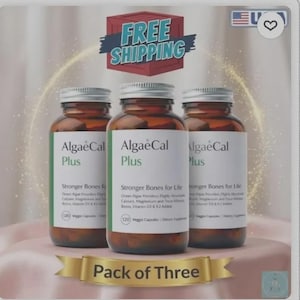 May include: Three brown glass bottles of AlgaeCal Plus supplements with white and green labels. The bottles are arranged on a pink surface with a gold ribbon that reads "Pack of Three". A red and blue sign says "FREE SHIPPING".