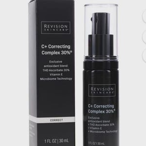 May include: A black skincare product bottle and box set. The bottle has a pump dispenser and a clear cap. The box and bottle both feature the text "REVISION SKINCARE" and "C+ Correcting Complex 30%" with a list of ingredients.
