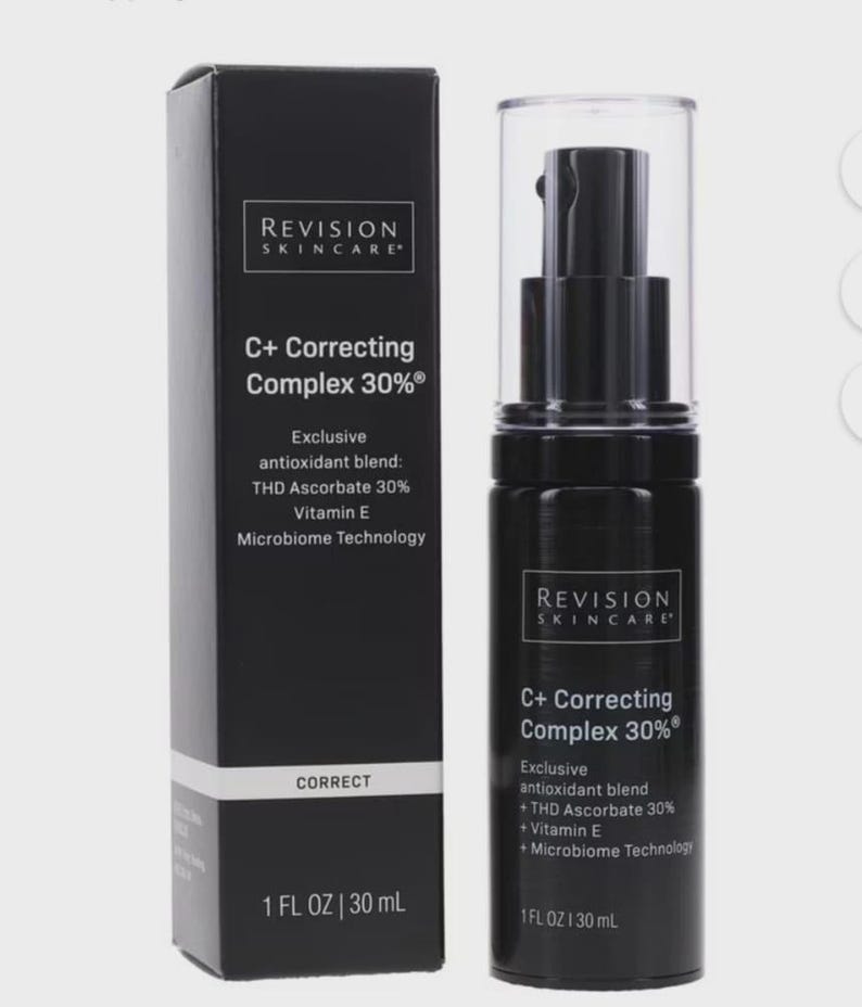 May include: A black skincare product bottle and box set. The bottle has a pump dispenser and a clear cap. The box and bottle both feature the text "REVISION SKINCARE" and "C+ Correcting Complex 30%" with a list of ingredients.