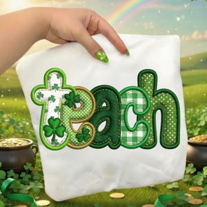 May include: White pillow featuring the word "Teach" embroidered in green, gold, and white. The letter "T" is cross-shaped with shamrocks. The letters have polka dots and plaid patterns.