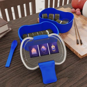 May include: A blue plastic bento box with a clear lid, containing sushi rolls. The lid features three Ramadan-themed illustrations. A blue spoon and chopsticks are also visible, suggesting a meal setting.