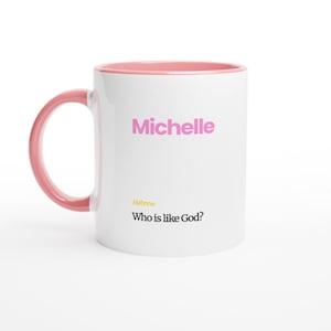 May include: White ceramic mug with a pink interior and handle. The mug features the name "Michelle" in pink letters, with the text "Hebrew Who is like God?" below.