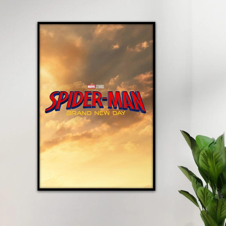 May include: A rectangular framed poster featuring a sunset sky with golden clouds. The text reads Marvel Studios Spider-Man Brand New Day in bold red and blue lettering with a yellow outline, centered against the atmospheric cloud background.