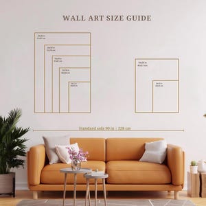 May include: A wall art size guide chart featuring gold outlines of various rectangular frames with dimensions in inches and centimeters. The chart includes text labels for sizes ranging from 8x10 inches to 24x36 inches and a standard sofa width of 90 inches.