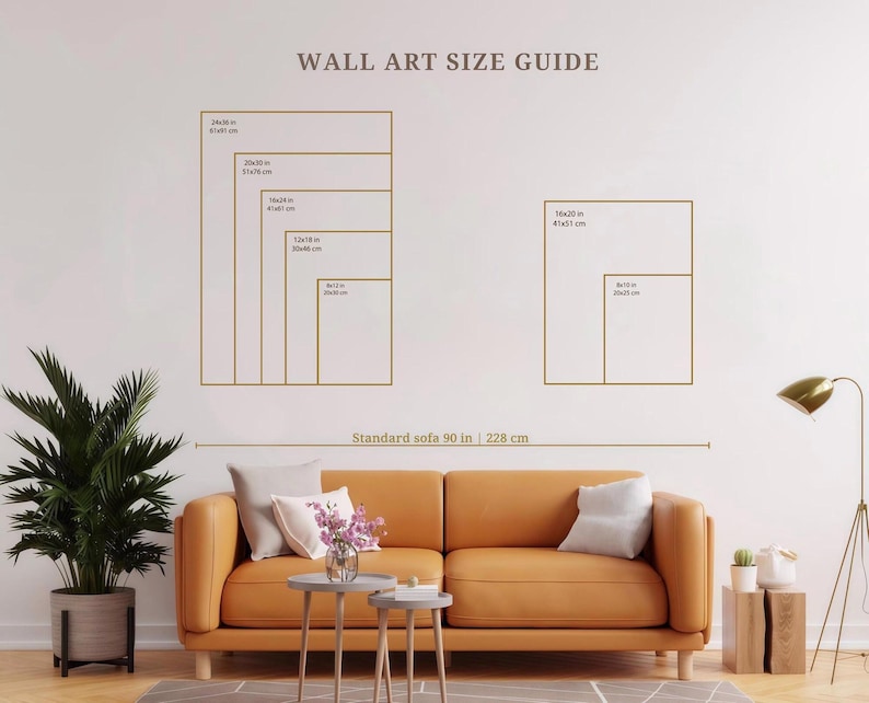 May include: A wall art size guide chart featuring gold outlines of various rectangular frames with dimensions in inches and centimeters. The chart includes text labels for sizes ranging from 8x10 inches to 24x36 inches and a standard sofa width of 90 inches.