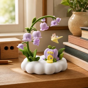 May include: A decorative figurine featuring a white cloud base, a green stem with hanging light purple bell-shaped flowers, a small purple pumpkin-shaped house with a yellow door, and a tiny white creature flying on a yellow paper airplane.