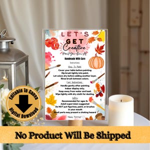 Può includere: Un cartello rettangolare con il testo LET'S GET CREATIVE Paint-Your-Own Kit, istruzioni e avvertenze di sicurezza. Il design include illustrazioni ad acquerello di foglie autunnali, una zucca e pennelli in arancione, rosso e giallo.
