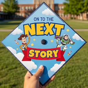 May include: A graduation cap with a blue background and the text "ON TO THE NEXT STORY". The cap features illustrations of Woody and Buzz Lightyear from Toy Story, with a black button in the center.