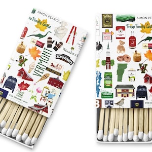 May include: Two boxes of matches with white backgrounds and colorful illustrations of Vermont landmarks, including a red barn, a maple leaf, a ski lift, a Ben & Jerry's ice cream shop, and a ski lodge. The text "Vermont" is printed in black on both boxes. The text "The Dorset Inn" is printed on the bottom of the box on the left. The text "Trapp Family Lodge" is printed on the top of the box on the right.