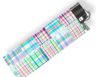 May include: A colourful plaid lighter with a silver top and a blue, green, pink and white plaid pattern.