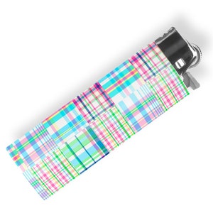May include: A colorful plaid lighter with a silver top and a blue, green, pink, and white plaid pattern.