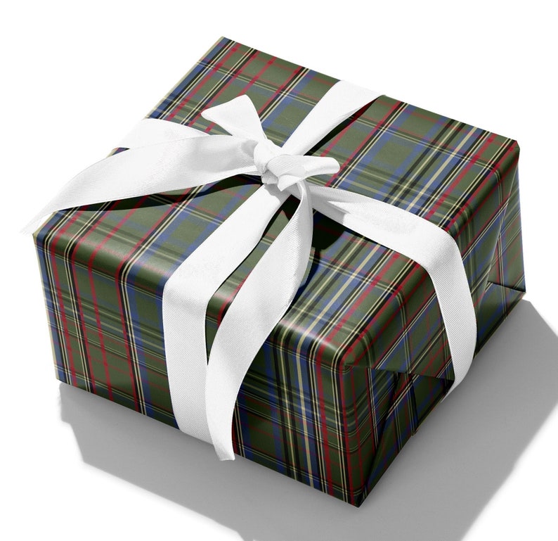 May include: A green, blue, and red plaid gift box with a white satin ribbon tied in a bow.
