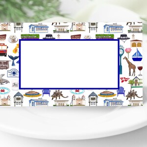 May include: A white place card with a blue border. The card is decorated with a pattern of colorful illustrations of various landmarks and symbols from Santa Barbara, California. The card has a blank space in the center for writing a name.