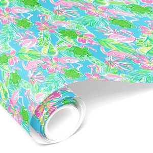 May include: A roll of wrapping paper with a tropical pattern featuring pink flamingos, green sea turtles, and pink and yellow flowers on a light blue background.