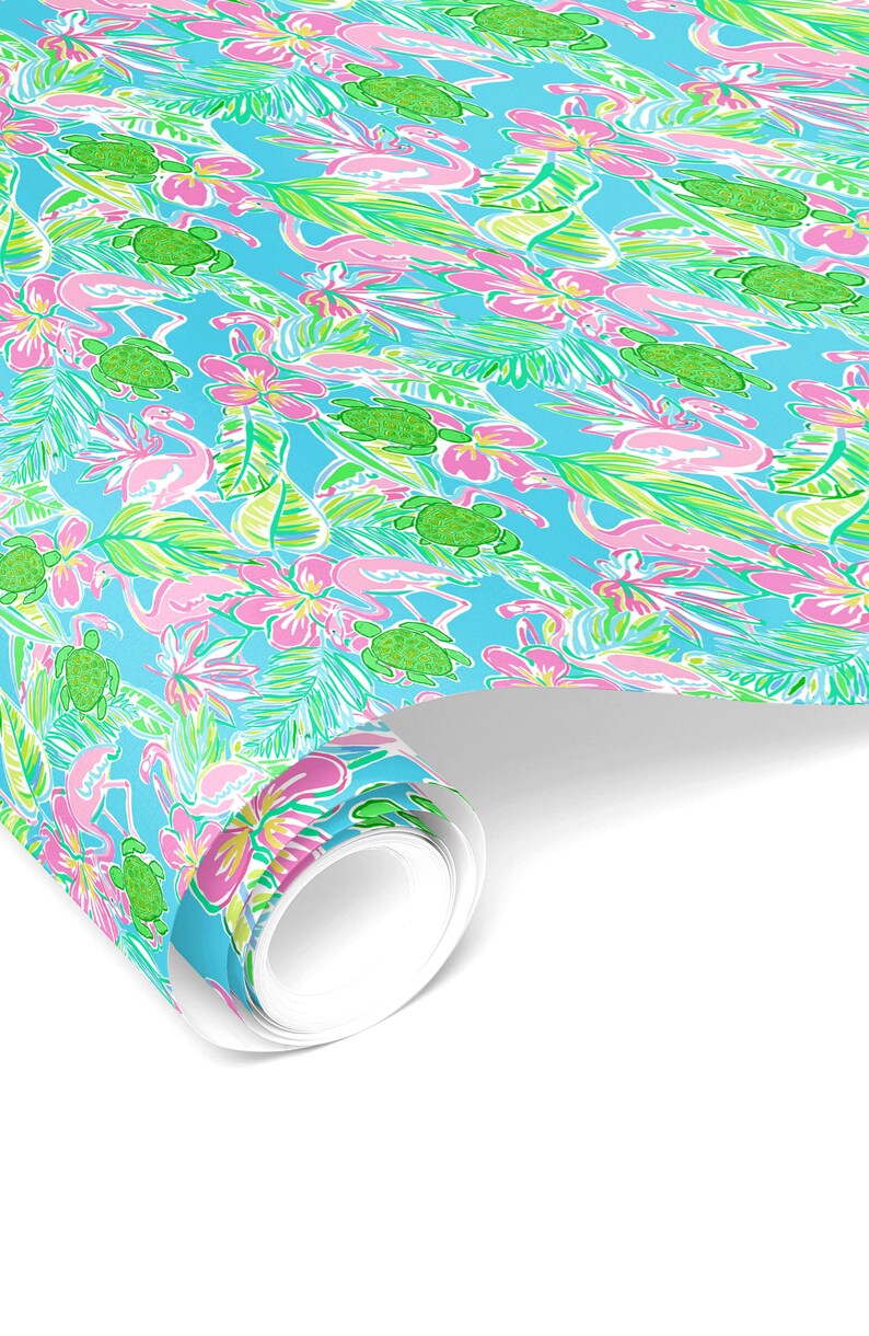 May include: A roll of wrapping paper with a tropical pattern featuring pink flamingos, green sea turtles, and pink and yellow flowers on a light blue background.
