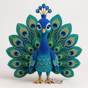 May include: A crocheted peacock figurine featuring a vibrant blue head and neck, with a large, fanned tail displaying intricate teal, green, and gold eye-shaped patterns. The figure has a golden beak, crest, and feet, with a tag reading Handcrafted Excellence.