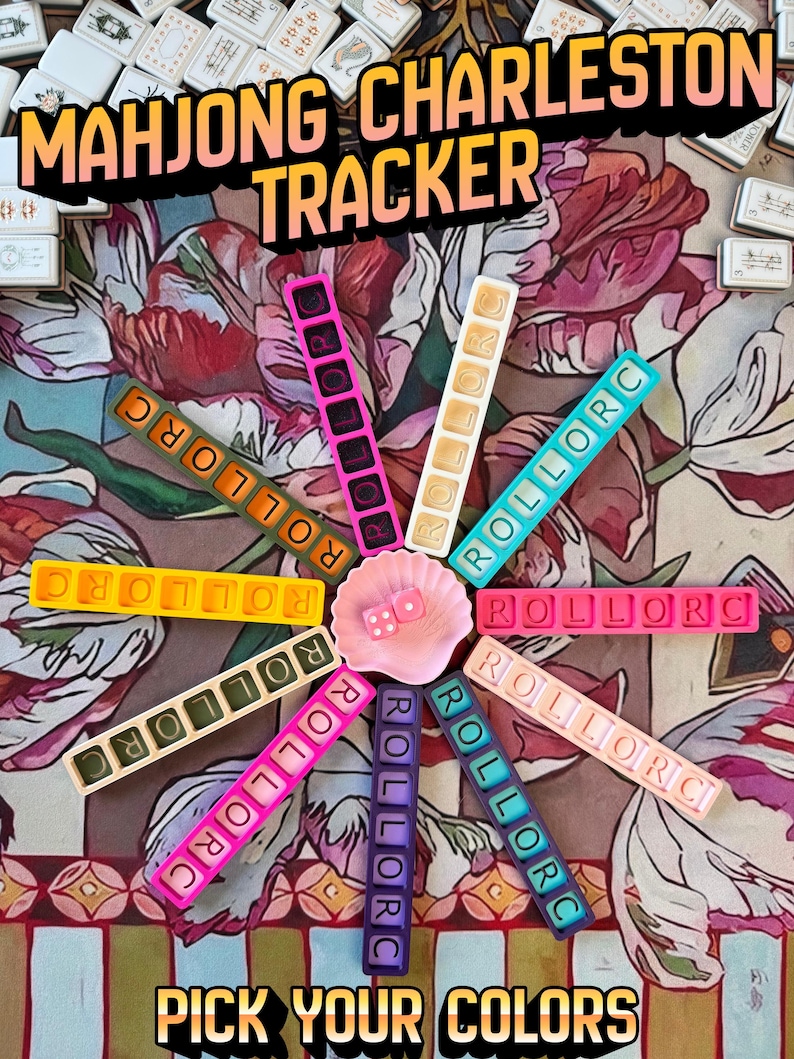 May include: A Mahjong Charleston Tracker set featuring ten colorful rectangular plastic bars with the text ROLLORC, arranged in a circle around a small pink shell dish containing two pink dice. The text MAHJONG CHARLESTON TRACKER and PICK YOUR COLORS is visible.