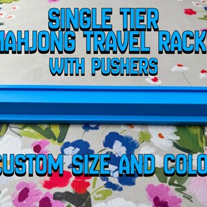 May include: A single-tier, bright blue Mahjong travel rack with pushers. The text on the image reads "SINGLE TIER MAHJONG TRAVEL RACKS WITH PUSHERS CUSTOM SIZE AND COLOR". The rack is designed to hold Mahjong tiles.
