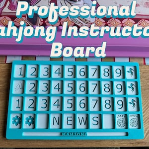 May include: A teal Mahjong board with white number tiles, a purple rack, and the text "Professional Mahjong Instructors Board." The board features numbers 1-9, bird, flower, and joker symbols. The word "NEWS" is also visible.