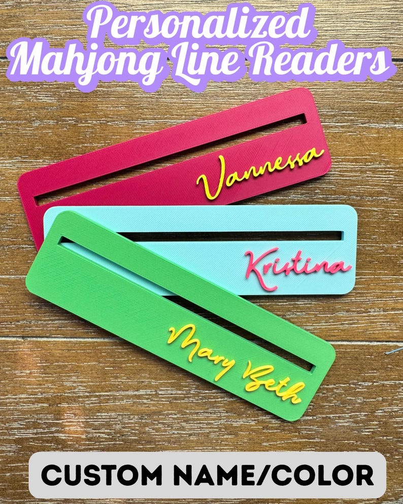May include: Three rectangular Mahjong line readers in magenta, light blue, and green. Each features a horizontal slot and a personalized name in raised script lettering: Vannessa in yellow, Kristina in pink, and Mary Beth in yellow.