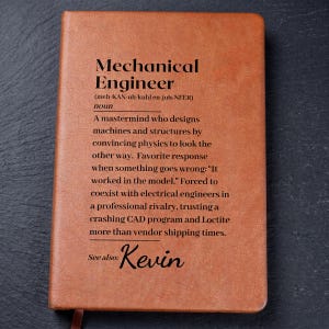 May include: A brown leather-bound notebook with the text "Mechanical Engineer" and a definition. The definition describes the role of a mechanical engineer. The name "Kevin" is also printed on the notebook.