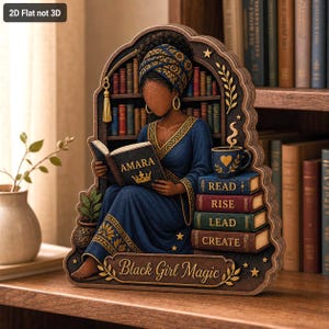 May include: A 2D flat wooden decorative sign featuring a person with a dark complexion wearing a blue patterned headwrap and dress, reading a book labeled AMARA with a crown. It includes a stack of books labeled READ, RISE, LEAD, CREATE and text reading Black Girl Magic.